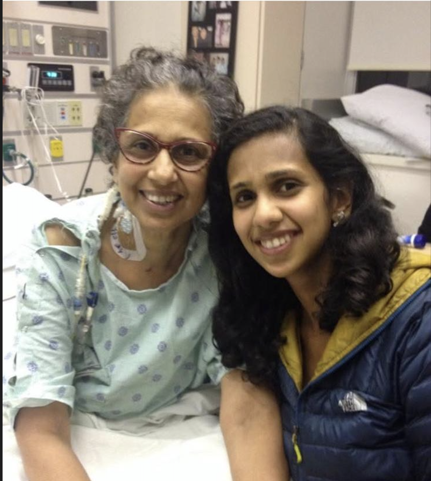 Dr. Ayonija Maheshwari smiling beside her mother in an ICU bed